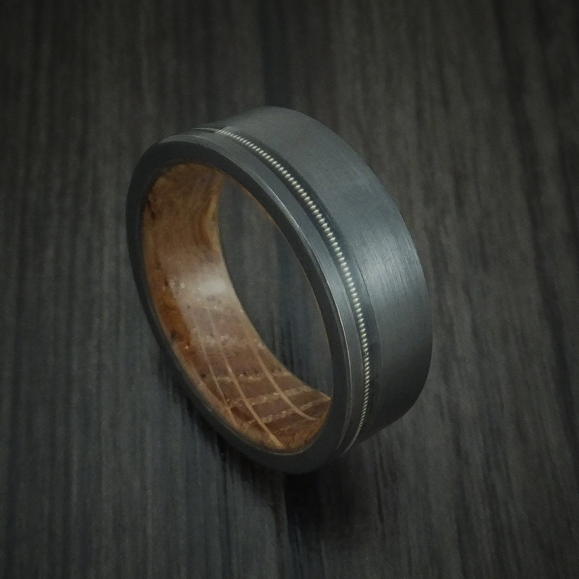 Black Titanium or Black Zirconium Custom Men's Ring with a Guitar String Inlay and Whiskey Barrel Hardwood Sleeve