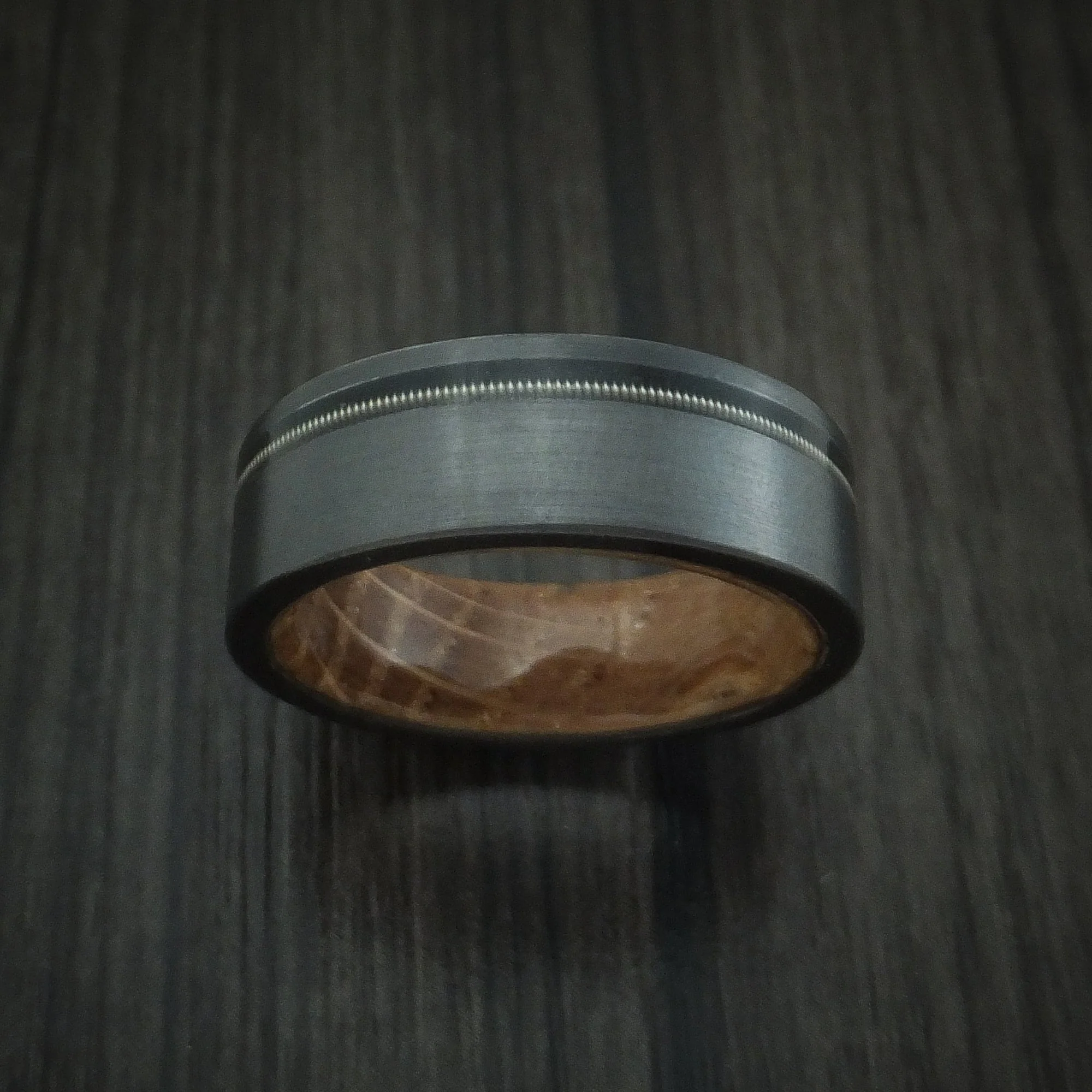 Black Titanium or Black Zirconium Custom Men's Ring with a Guitar String Inlay and Whiskey Barrel Hardwood Sleeve - Image 2