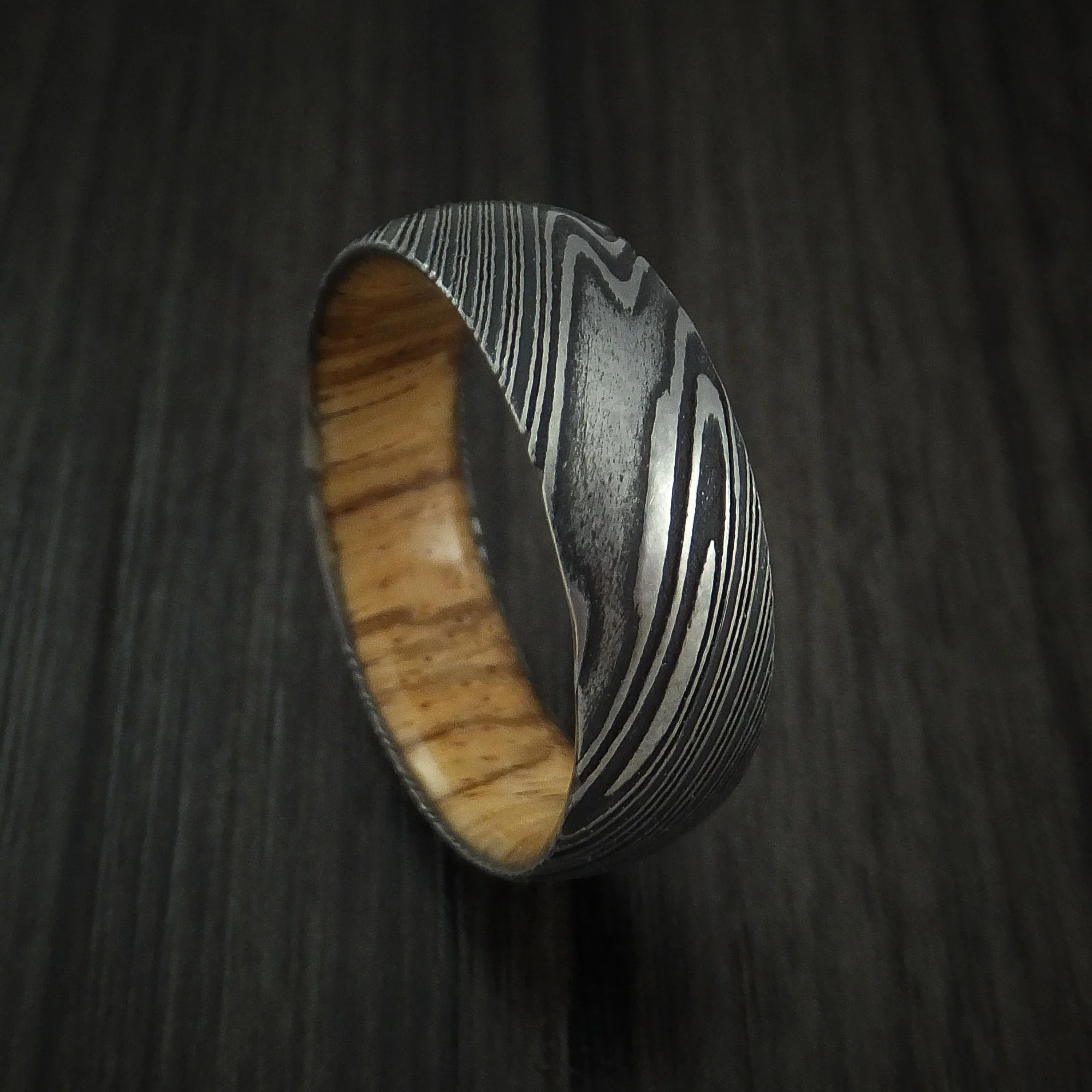 Woodgrain Kuro Damascus Steel Men's Ring with Zebra Wood Hardwood Sleeve Custom Made Wood Band